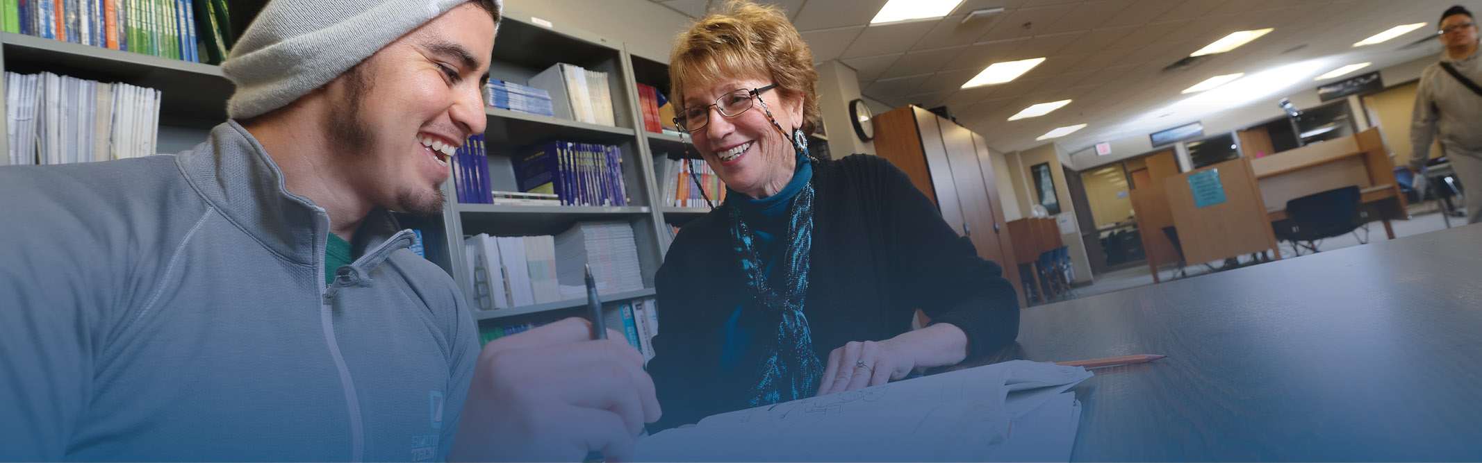 Student and tutor in library setting