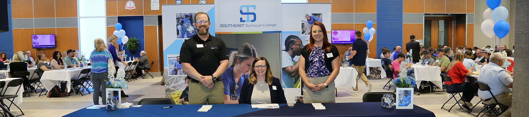 Campus Visit Welcome Desk with three admissions representatives