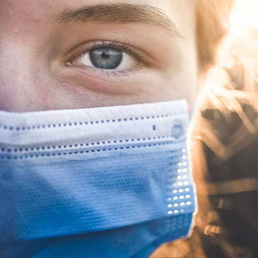 person wearing facemask with blurred background