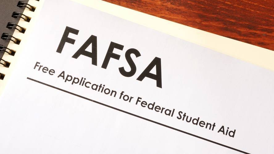 Paper copy of FAFSA application on wood desk