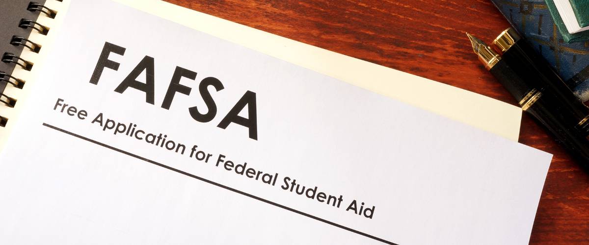 Financial Aid application page FAFSA form on wood desk