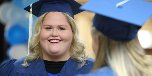 young woman in graduation cap and gown