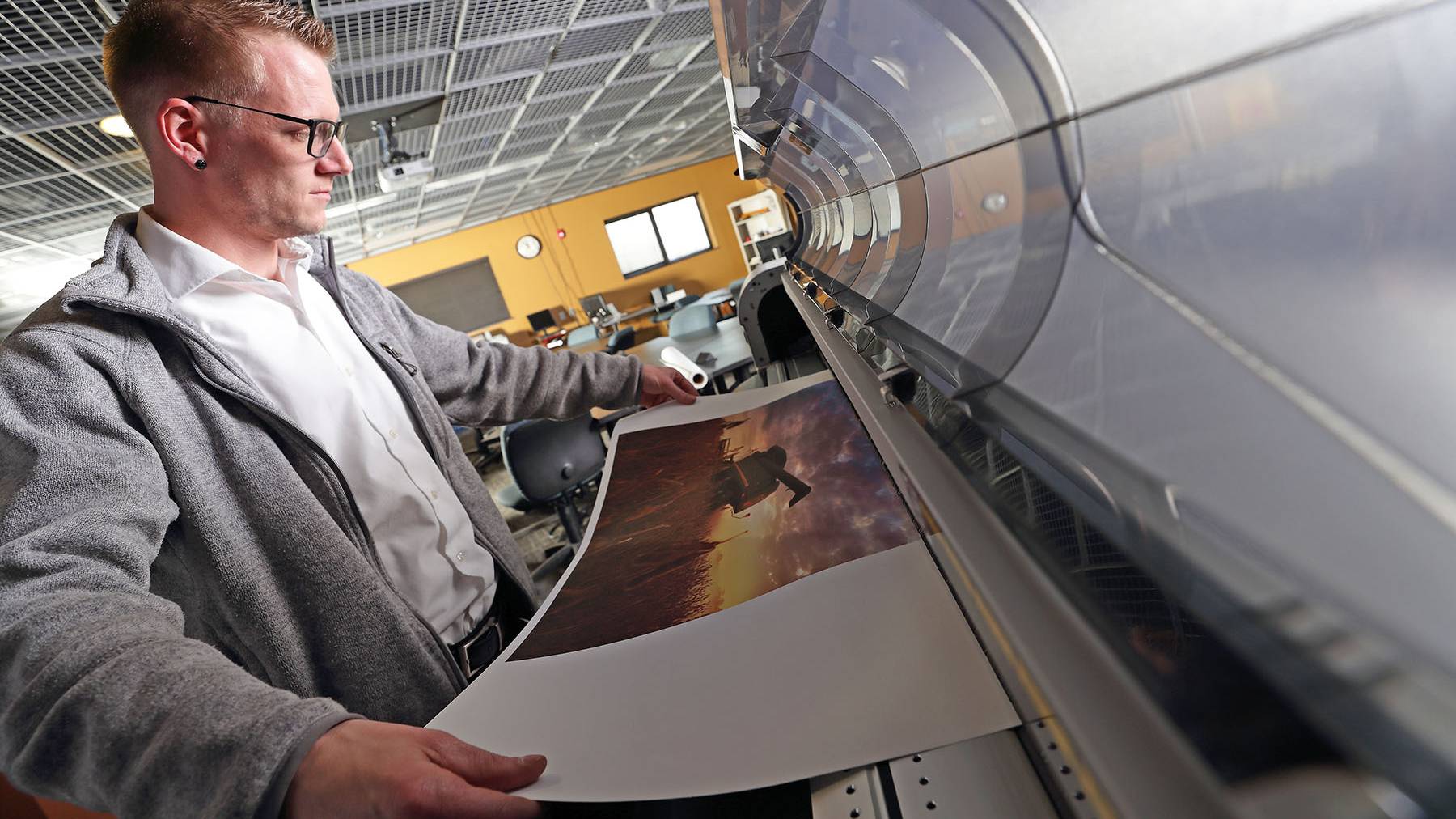 student using large format printer