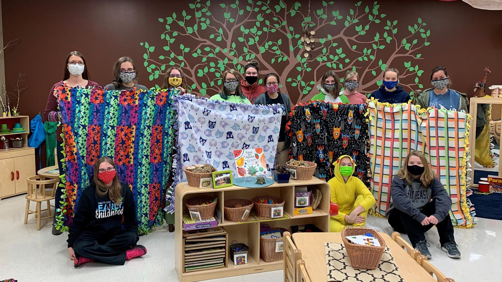 Students in masks with homemade blankets