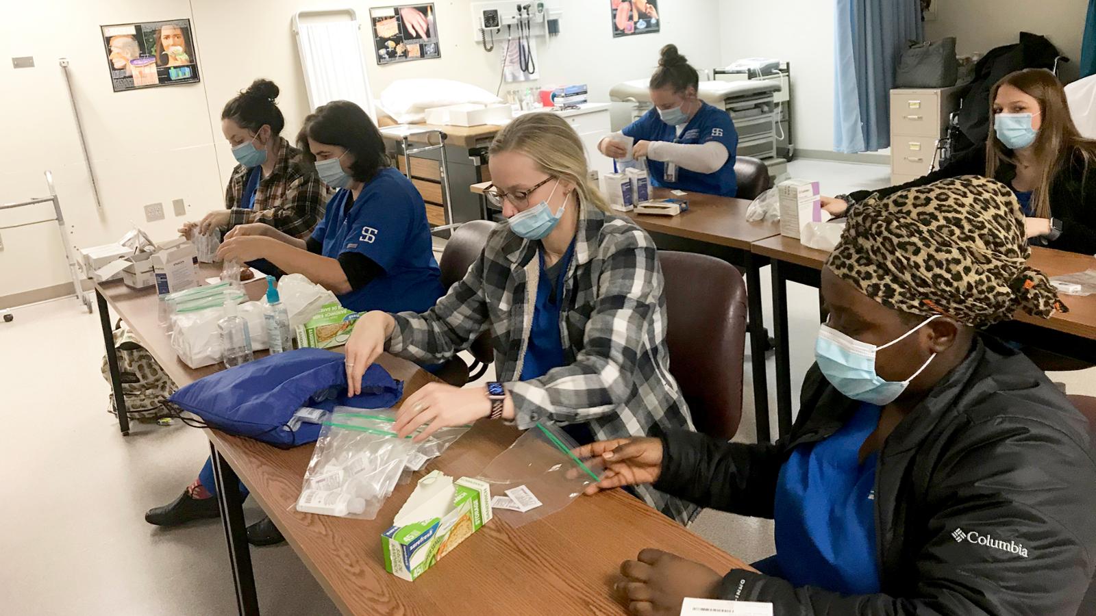 students in classroom assembling kits