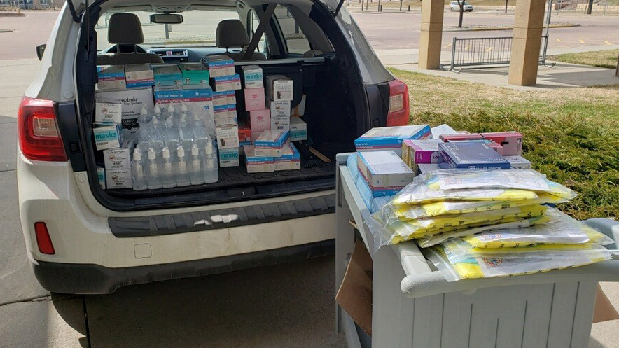 Trunk of vehicle filled with boxes of PPE for donation