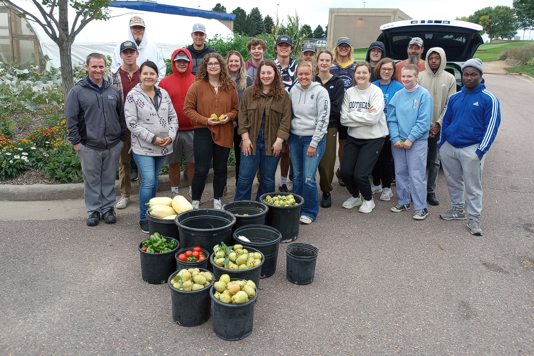 Group photo of students and horticulture harvest