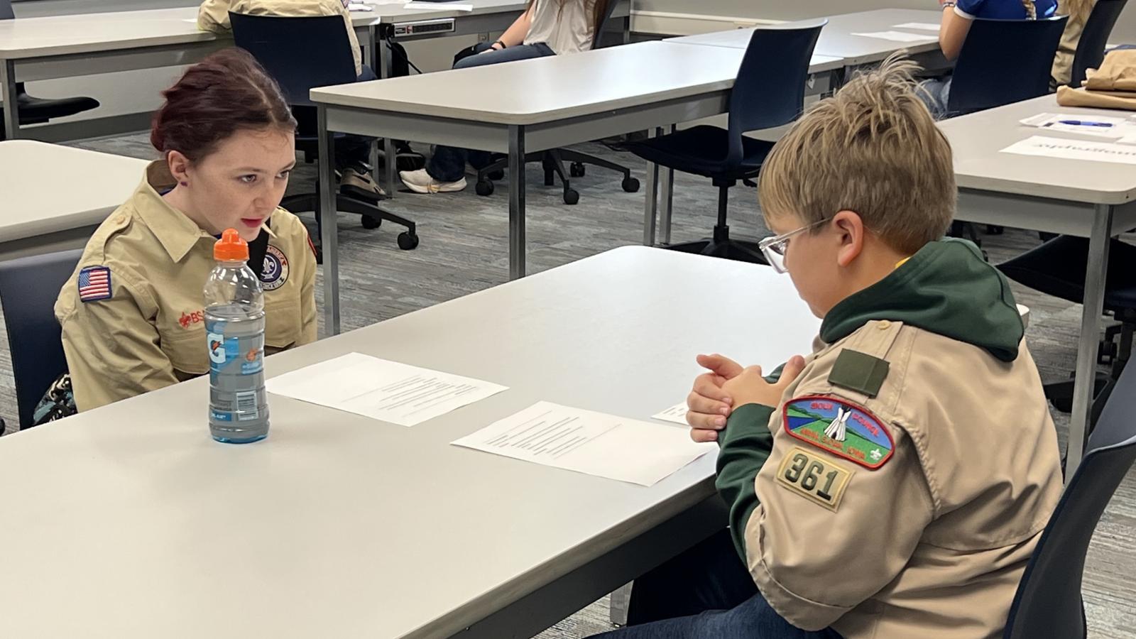 Merit Badge Camp 2025 two scounts seated across a table working on an activity