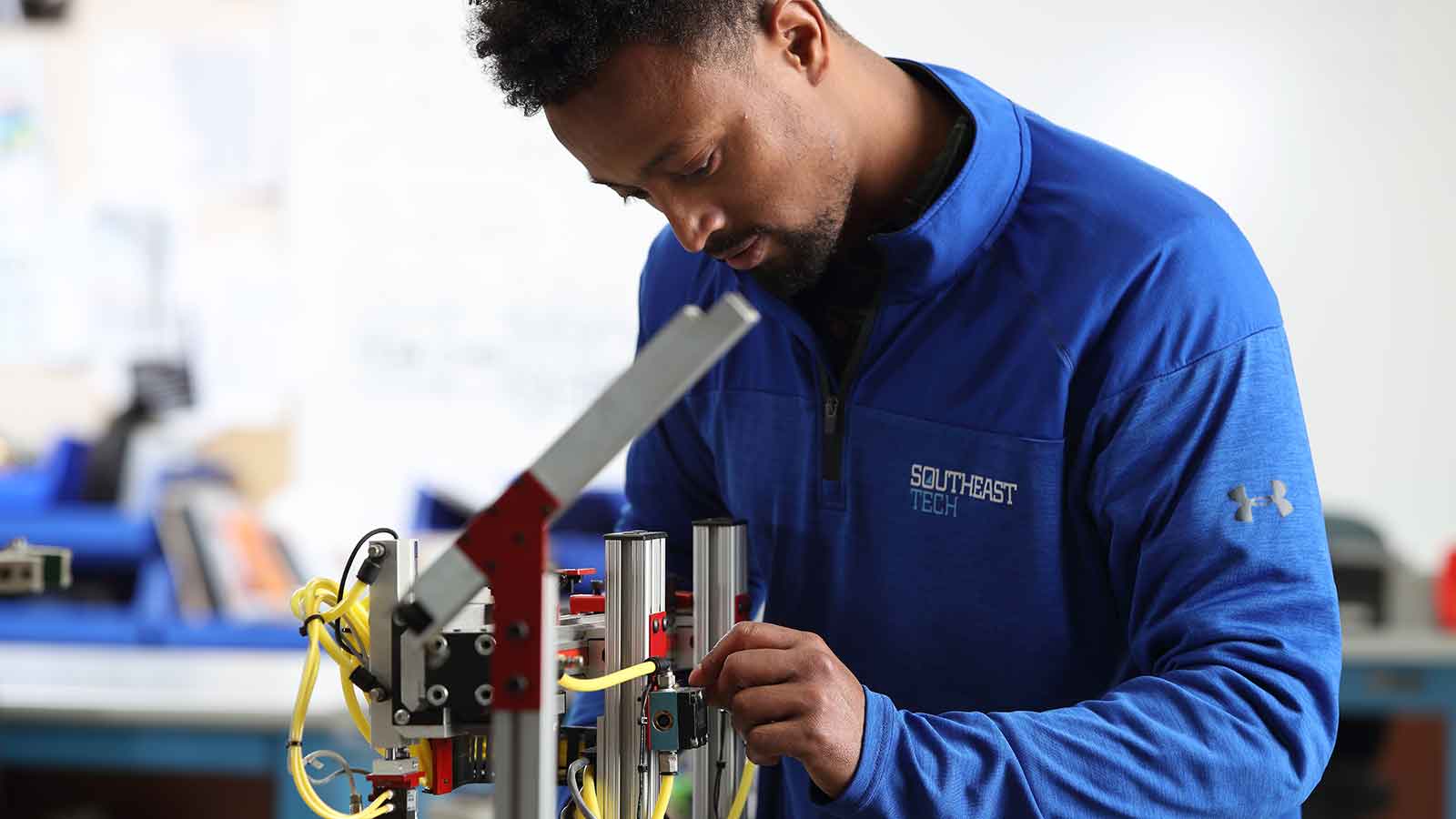 Mechatronics student working on robotic arm