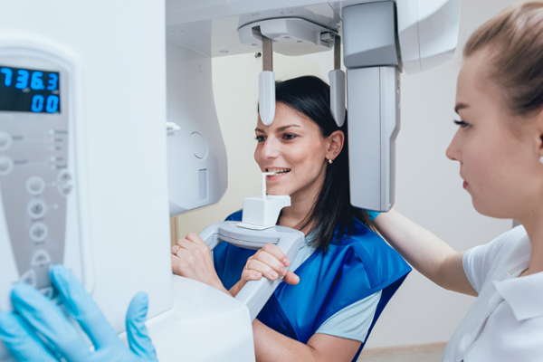 Technician helping patient take xrays