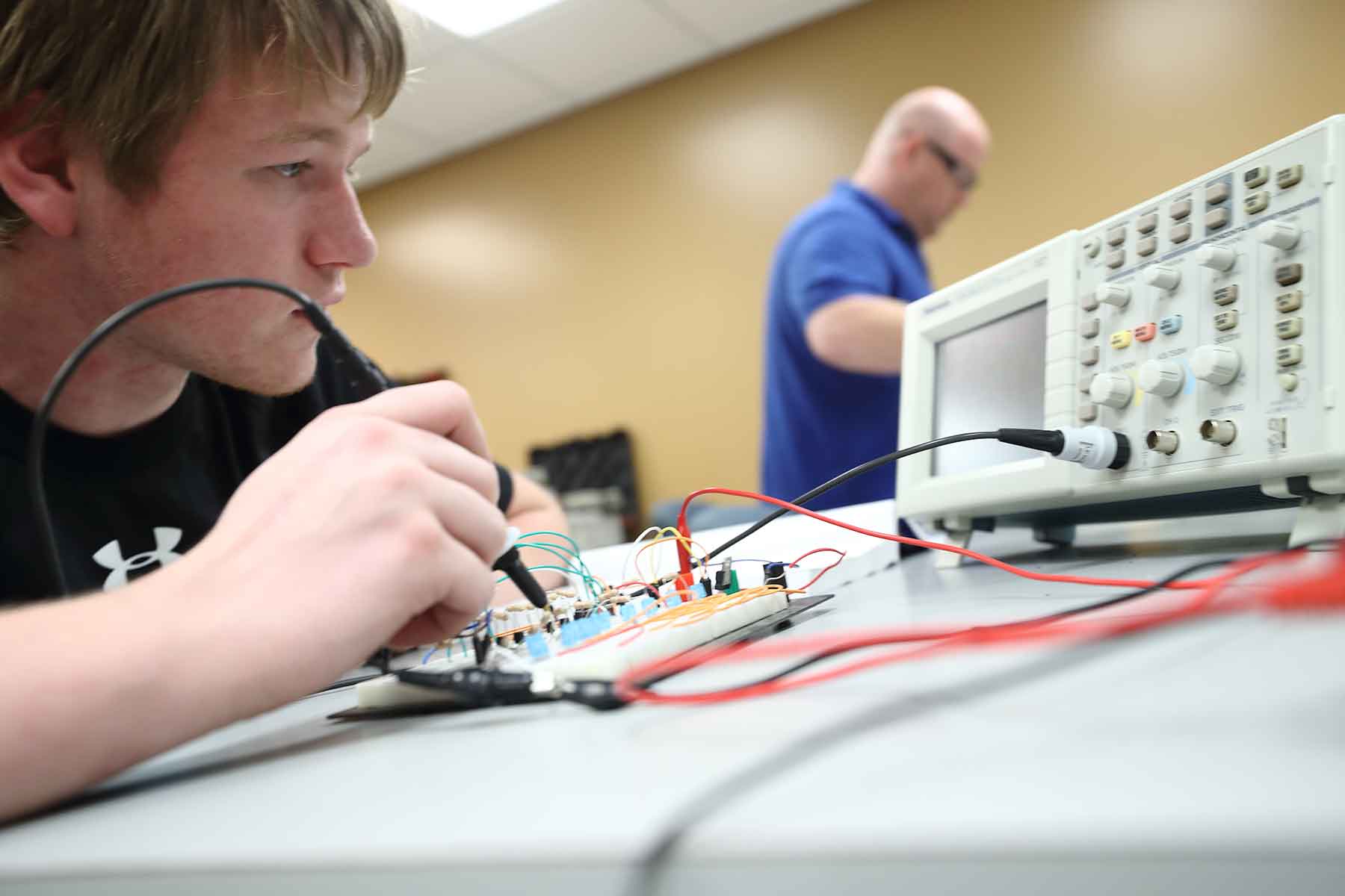 Electronics student testing board