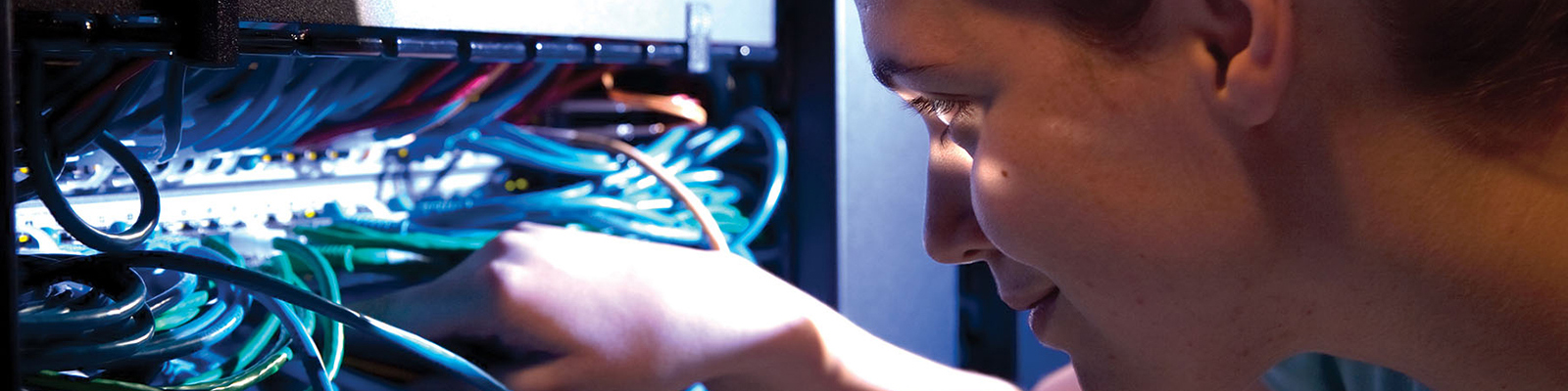 student adjusting networking wires