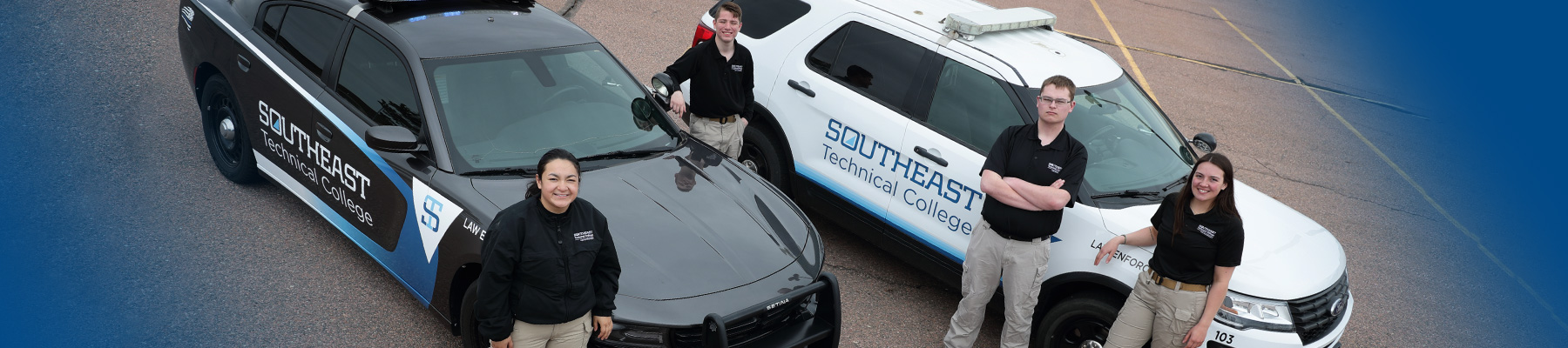 Students in front branded LE vehicles.