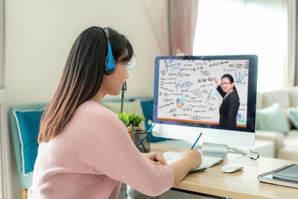 female at study desk with computer