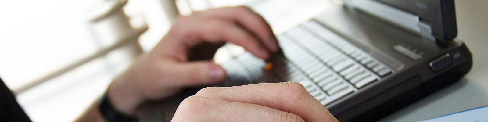 Hands on a laptop keyboard