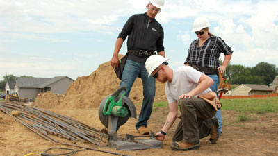 Students working outdoors at a homebuilding site