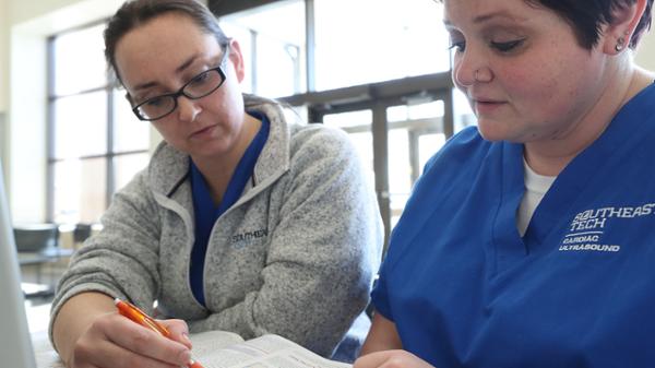 Adult Learners Adult females studying together in lighted student lounge