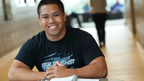 Adult Learners Smiling young man in STC t-shirt
