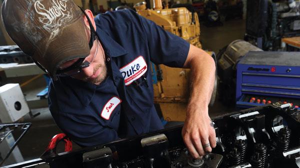 Adult Learners Man with beard working on diesel engine