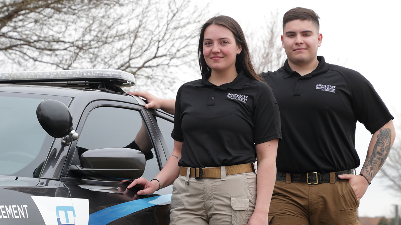 LE students by vehicle in uniform