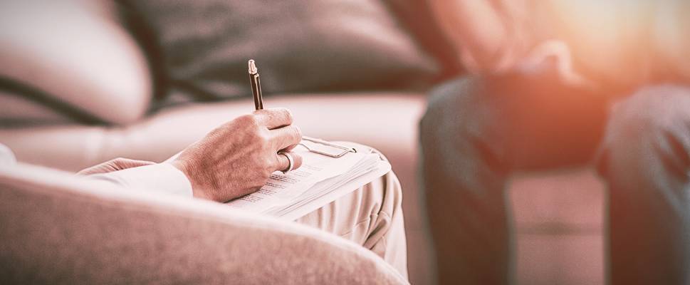 Counselor with notepad and pen