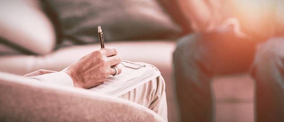 Request Counseling Services Counselor with notepad and pen