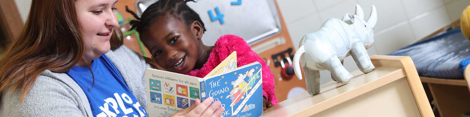 teacher with child and book