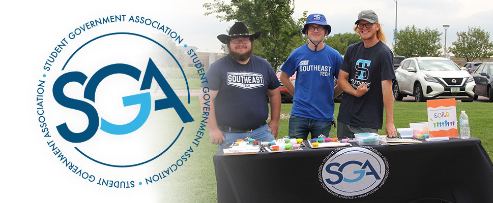 SGA logo and members at registration table