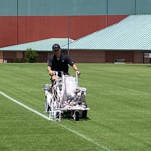 Jesse Tschetter painting field lines on the Atlanta Falcons training field.
