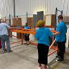 Business students at STC employees volunteer at the Habitat for Humanity ReStore facility.